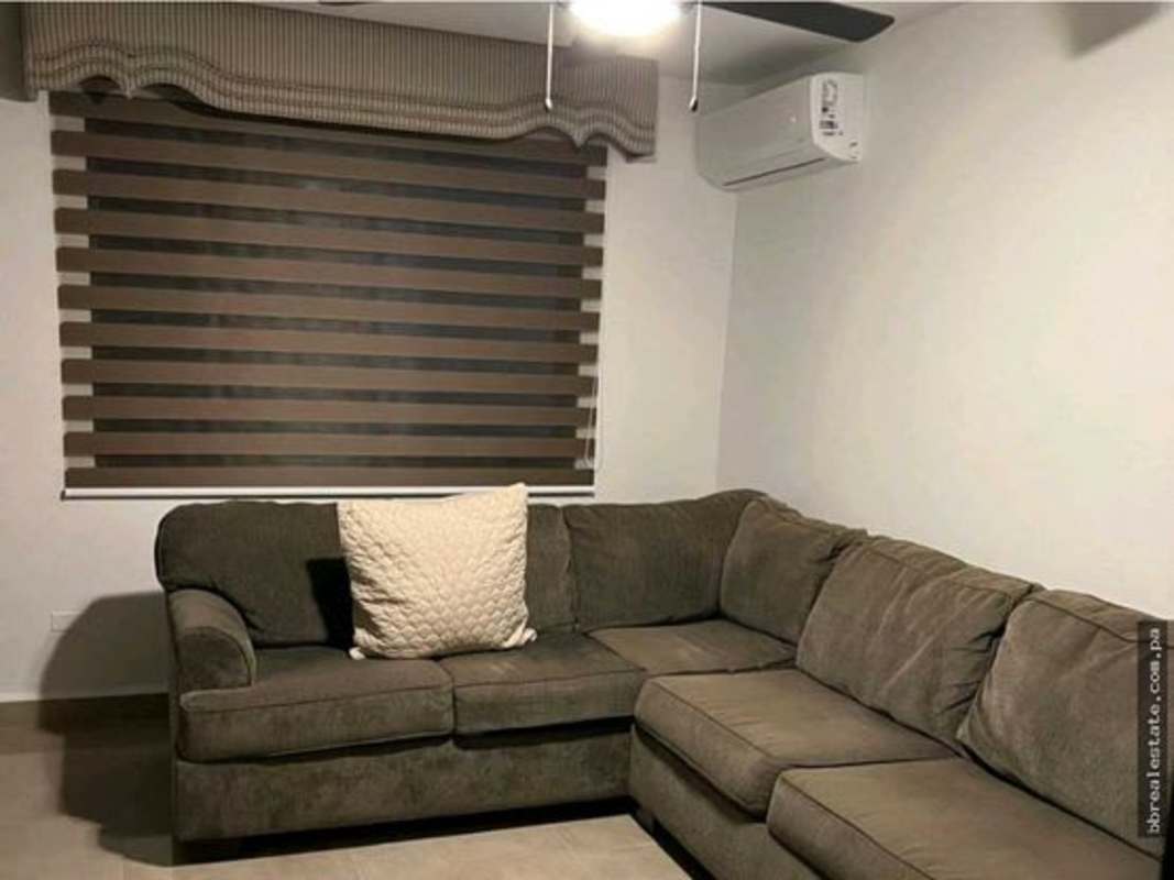 Elegant living room with floor-to-ceiling windows, city views, contemporary furnishings at PH Country Park San Francisco Panama