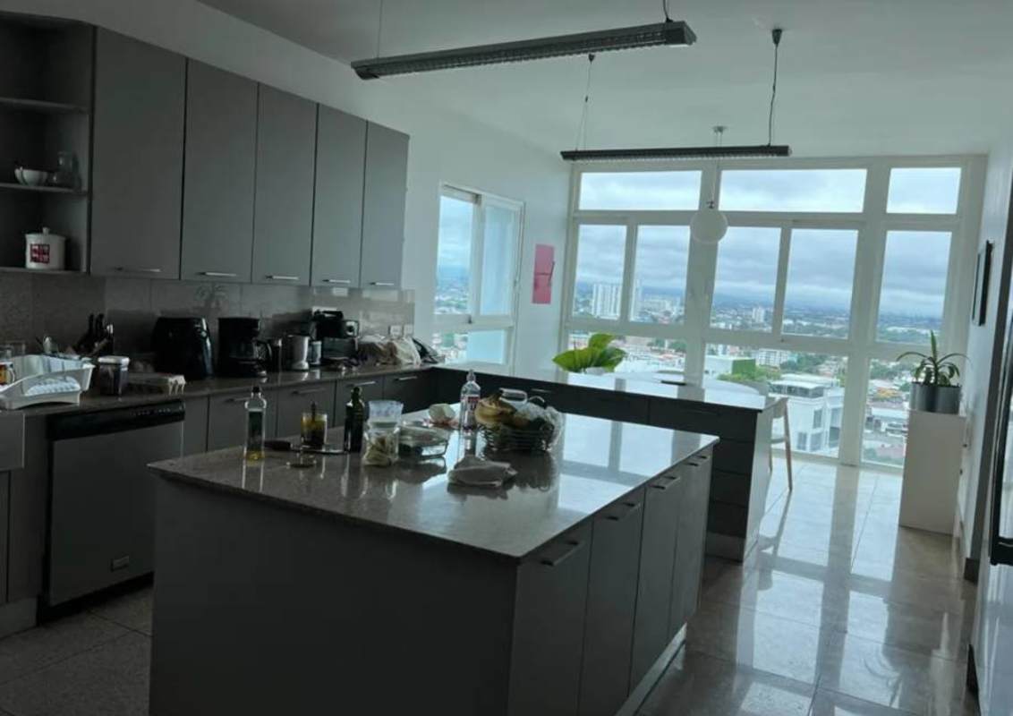 Spacious kitchen with granite counters and breakfast nook overlooking city in PH Pradera Altos del Golf