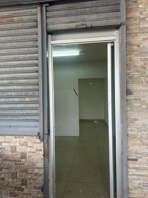 Commercial space exterior on street level with rolling shutter and tiled entrance in Panama