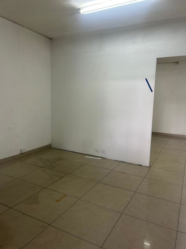 Commercial storefront exterior with glass door and rolling metal shutter on Vía España, Panama City