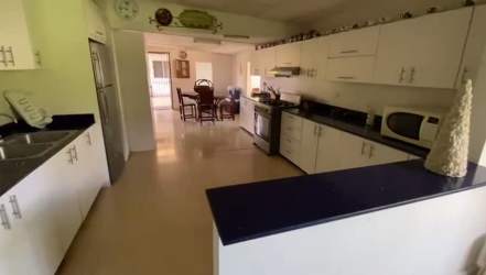 Bright dining area with view of garden and pool at Coronado Panama beach home