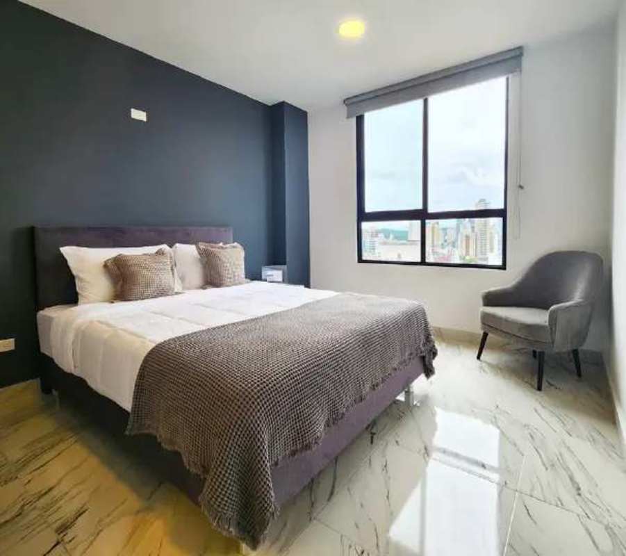 Granite countertop kitchen with large window and city skyline view at The Gray Tower Panama City