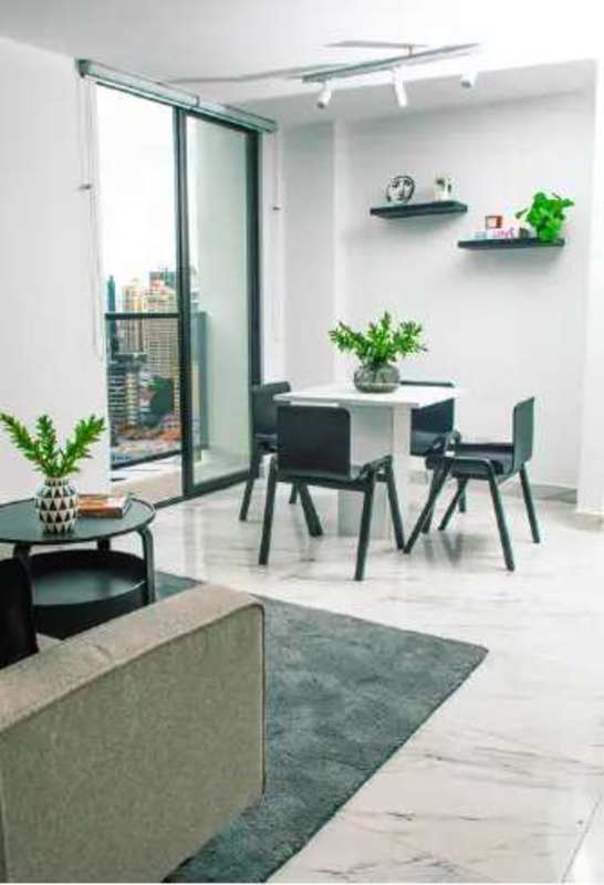 Modern apartment living dining area with large windows and Panama City skyline views at The Gray Tower