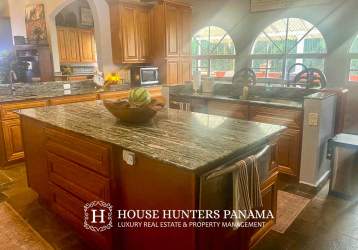 Spacious bedroom suite with large window, wood finishes and terrace access Victorian style Valle Escondido Boquete Panama