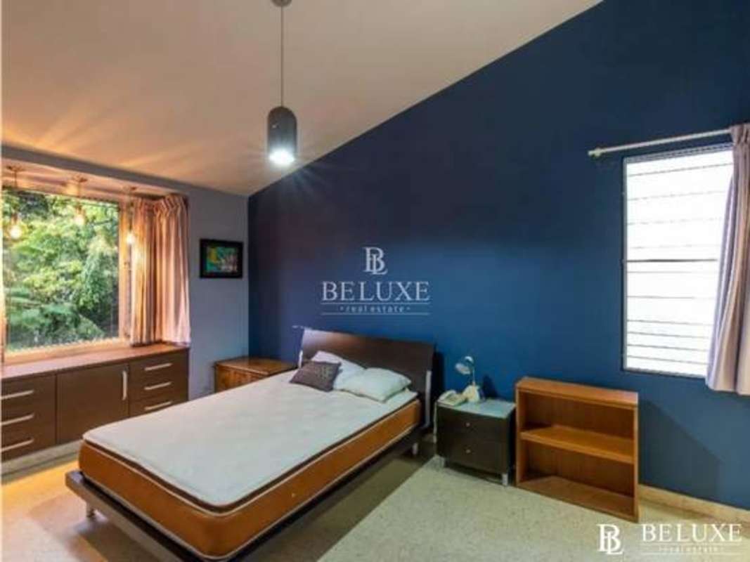 Bright living room overlooking lush tropical gardens in duplex house Obarrio Panama