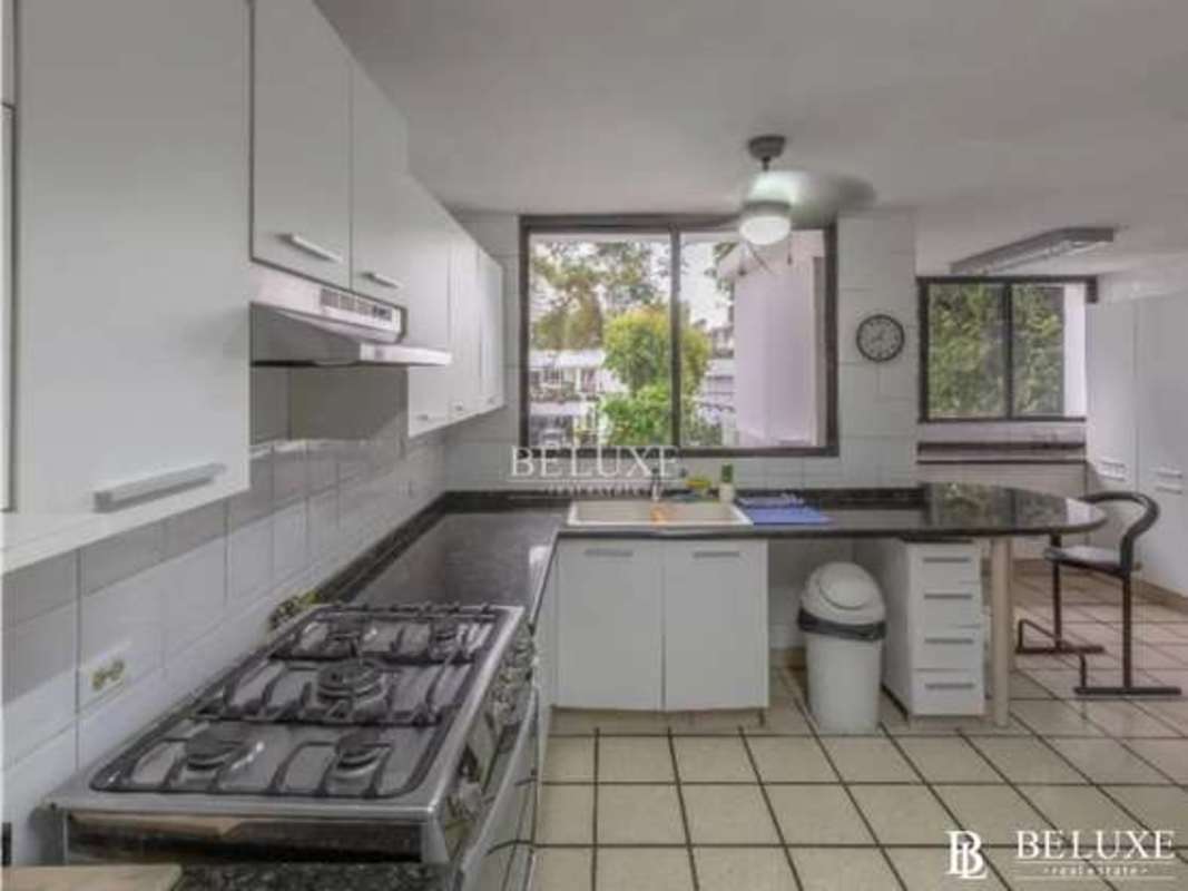 Modern white kitchen granite counters large windows duplex house Obarrio Panama