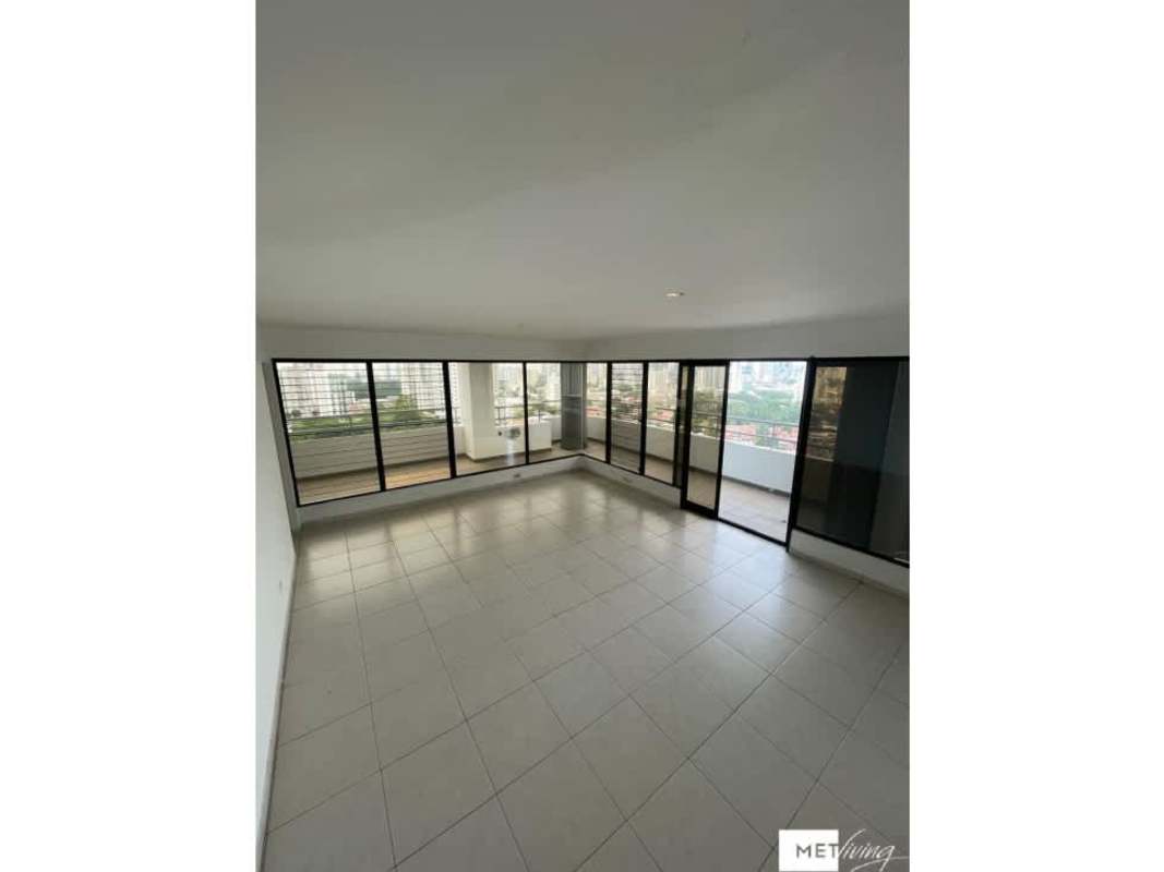 Spacious modern living room with balcony access and city views at PH La Loma