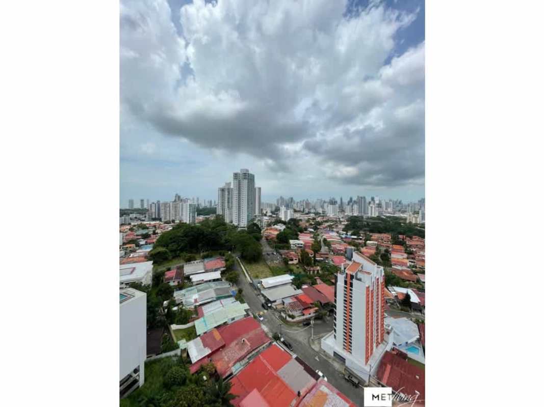 Modern living room with panoramic windows opening to balcony city views La Loma Panama