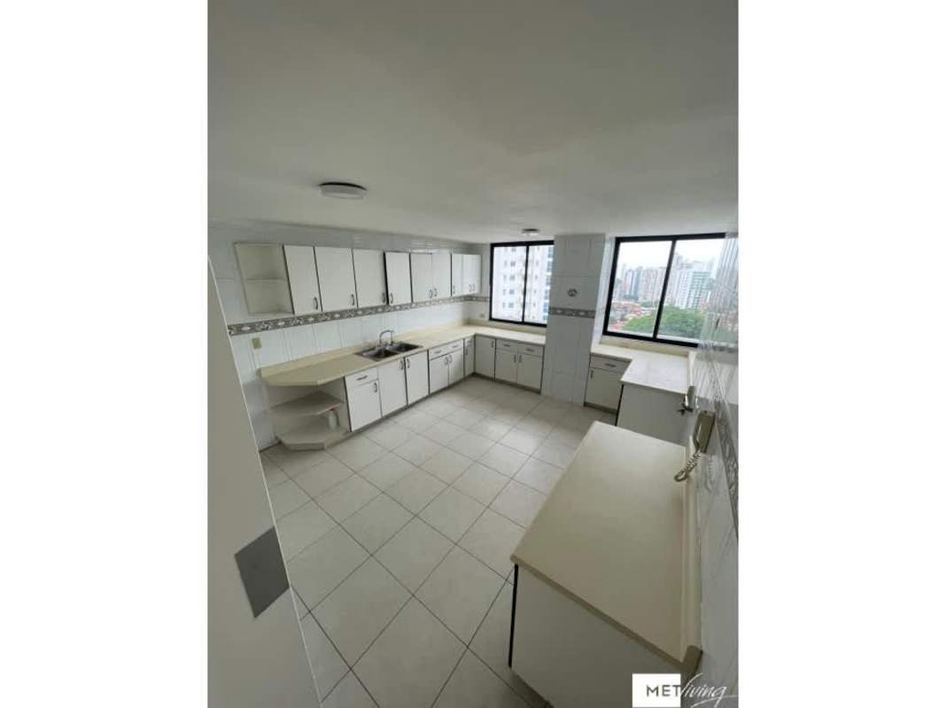 Bright kitchen featuring white cabinetry, beige counters, large windows with skyline Panama