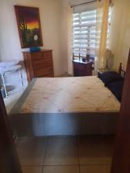 Outdoor community swimming pool surrounded by gardens at Cuesta del Sol David Panama