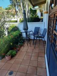 Traditional bathroom vanity with granite countertop and shower in Cuesta del Sol David Panama