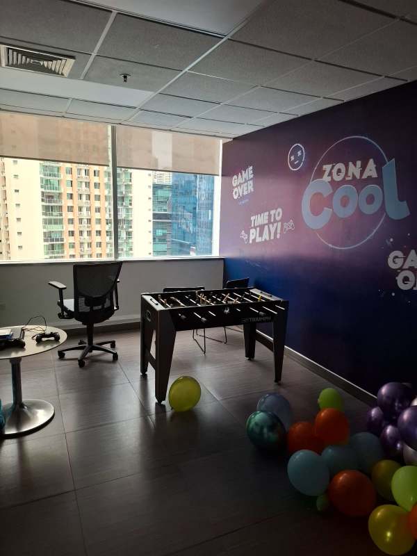 Office break room with foosball table and city views at Torre de las Américas Punta Pacífica