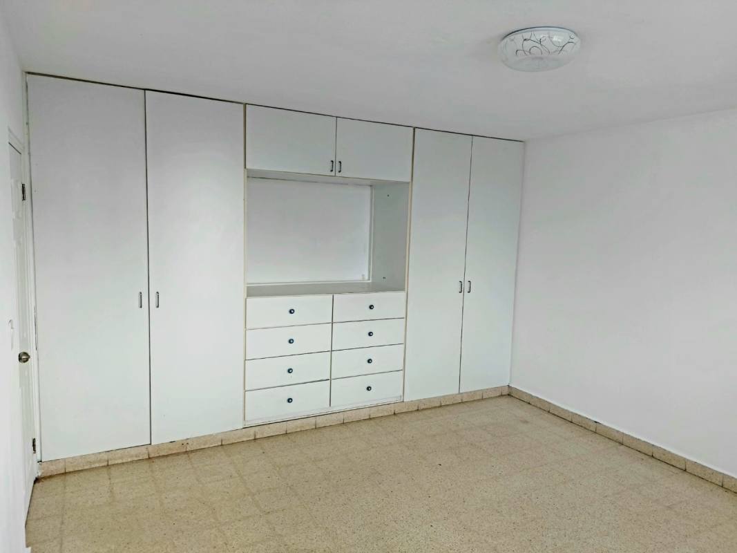 Bedroom with large window and tiled floors in PH Aileen Bella Vista Panama City apartment