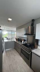 Open American style kitchen with granite counters and stainless appliances in PH Solea Punta Barco Panama