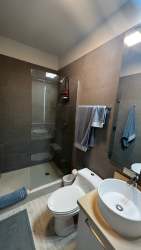 Open living dining space with big windows and terrace access at PH Solea beach condo Panama