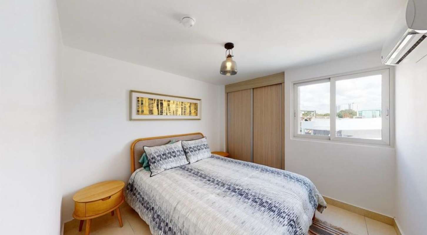 Bedroom with double bed, large window, built-in closet in Panama Viejo Residences Panama