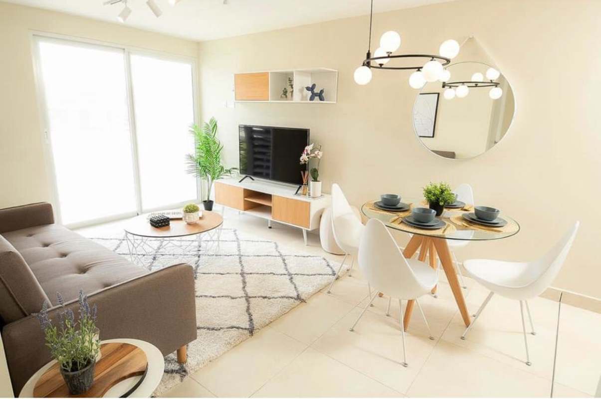 Mid-century modern living area with brown sofa, dining set Panama Viejo Panama