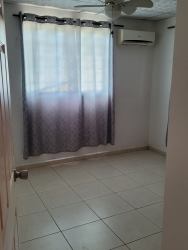 Small bathroom with pedestal sink, wall mirror tile walls Panama house.