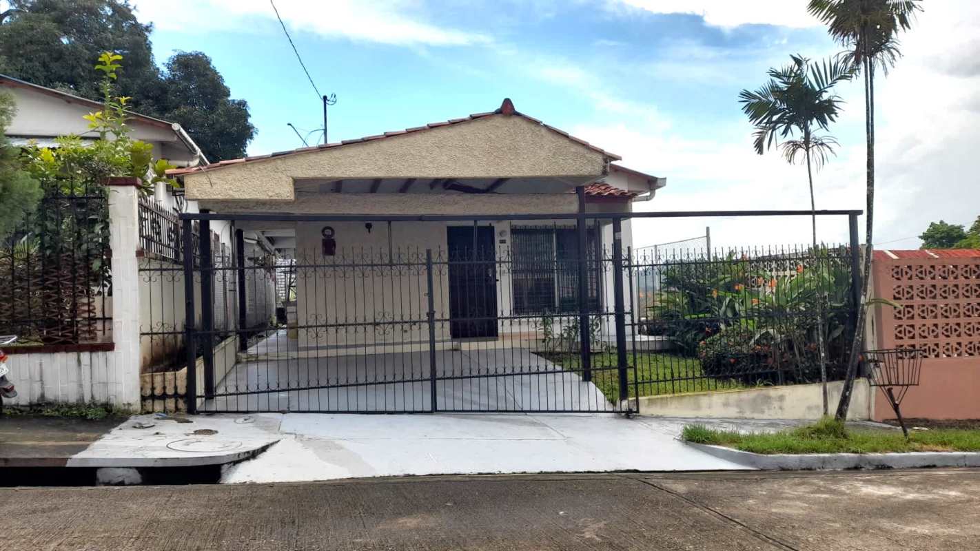Gated porch and driveway with garden area in Altos del Chase house Panama City
