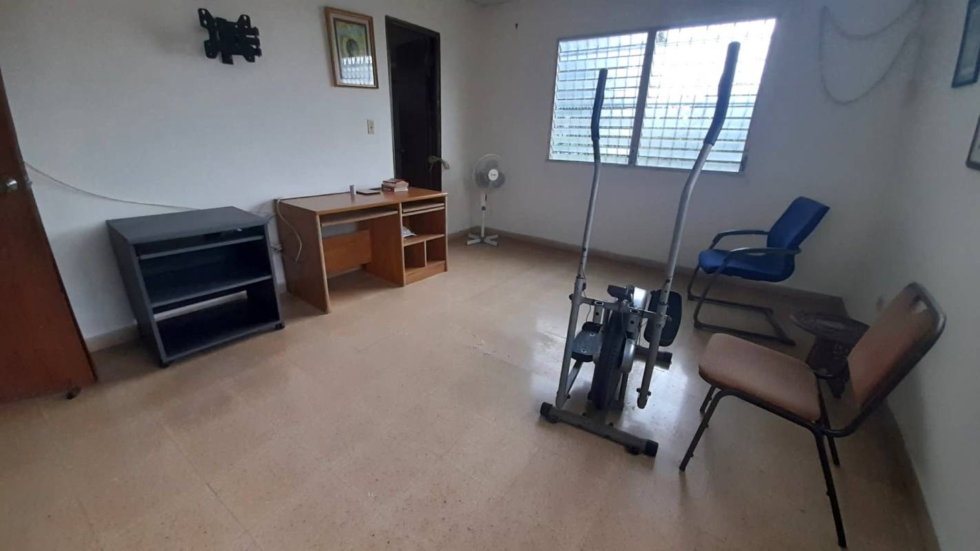 Simple bedroom with built-in wardrobe and natural window light Panama
