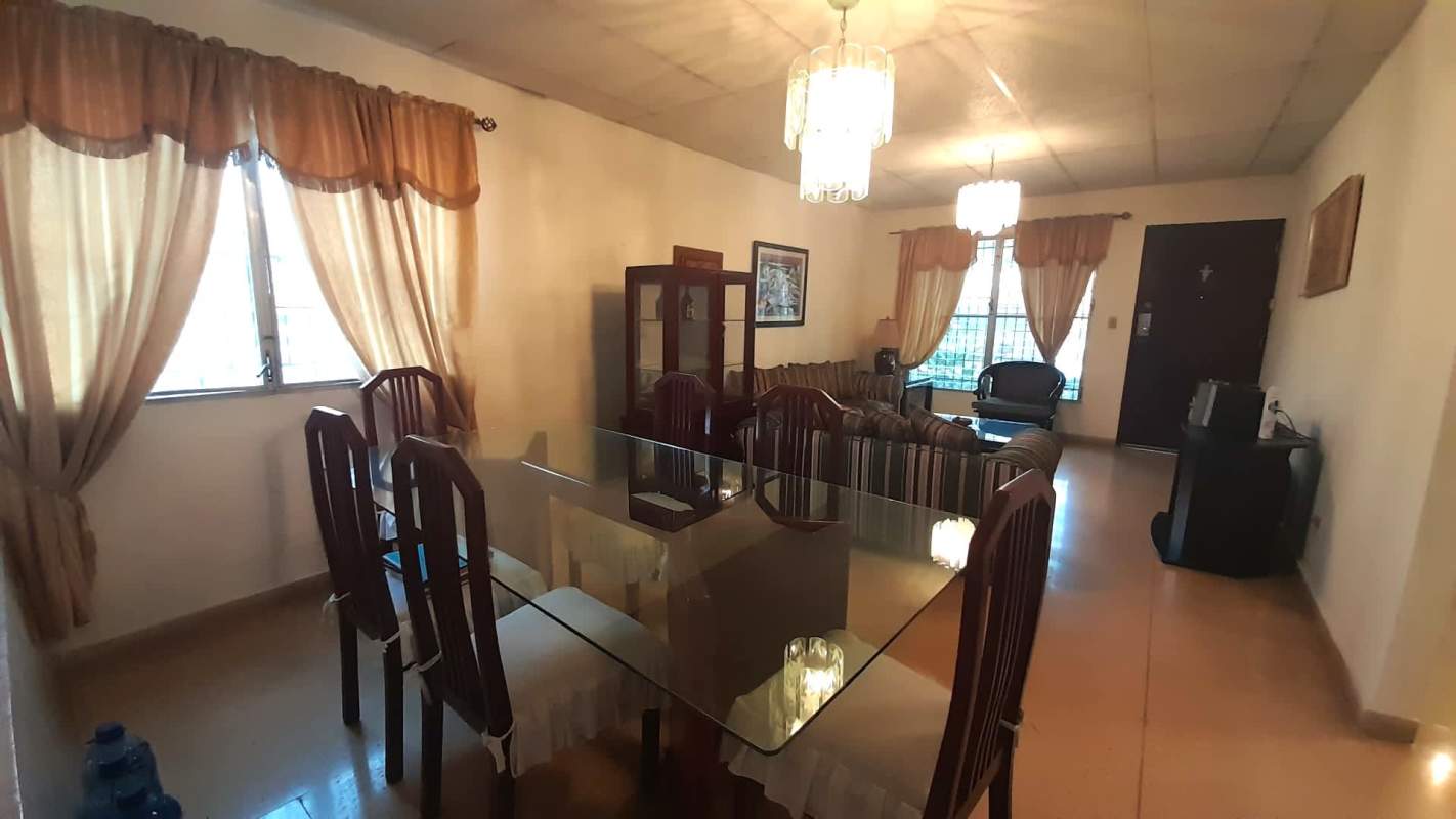 Combined living and dining traditional decor with large windows in Panama house