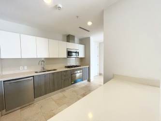 Contemporary kitchen with stainless appliances and stone counters in Puntarena Buenaventura condo