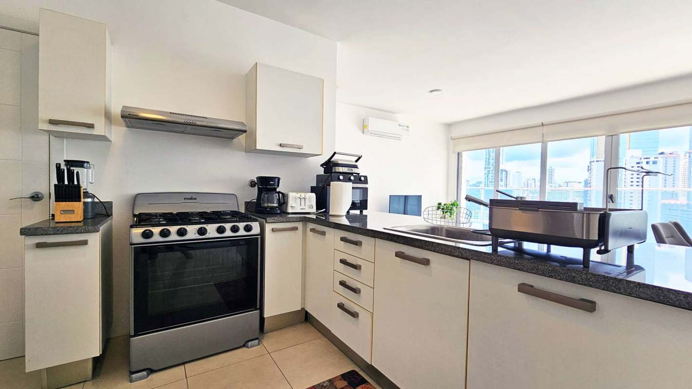 Modern bedroom with walk-in closet, large windows, city views, PH Waters on the Bay