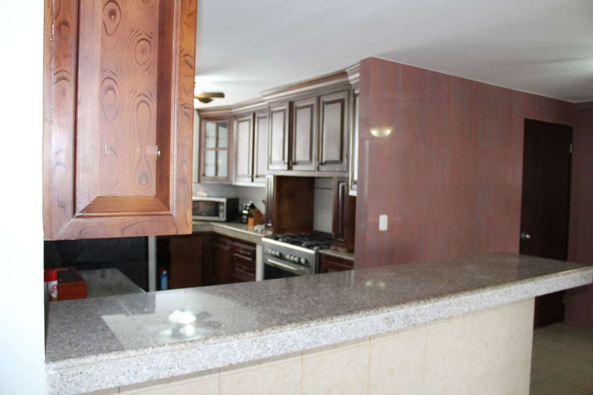 Traditional style kitchen with granite counters and wood cabinets in apartment for sale Obarrio Plaza Panama