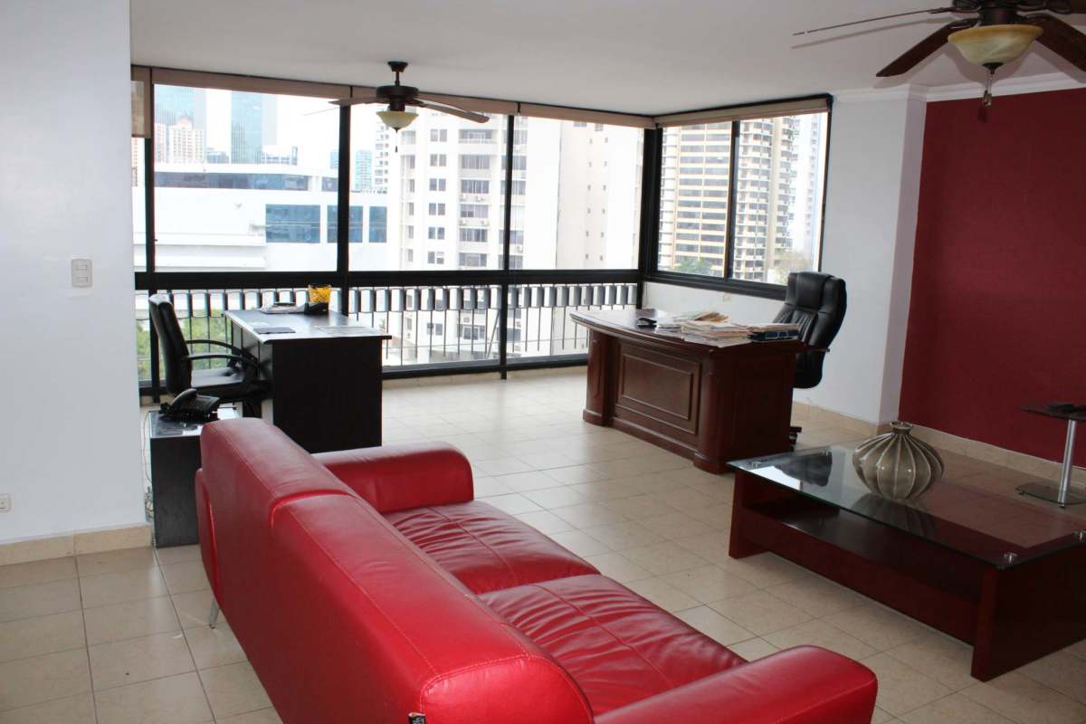 Executive office room with panoramic city views, large windows, tile floors in Obarrio Plaza Panama apartment
