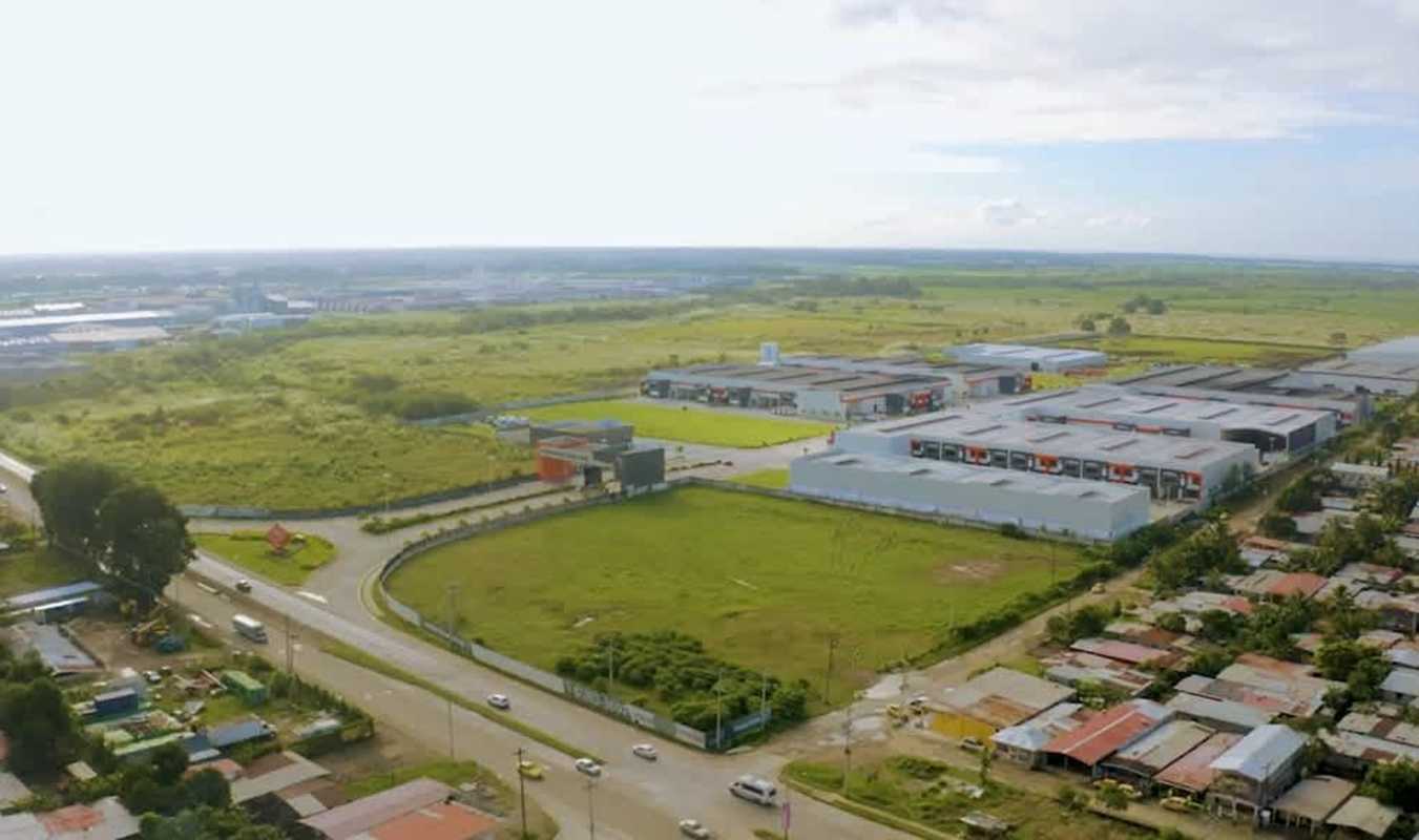 Aerial of multiple warehouses within Panapark Free Zone surrounded by green areas