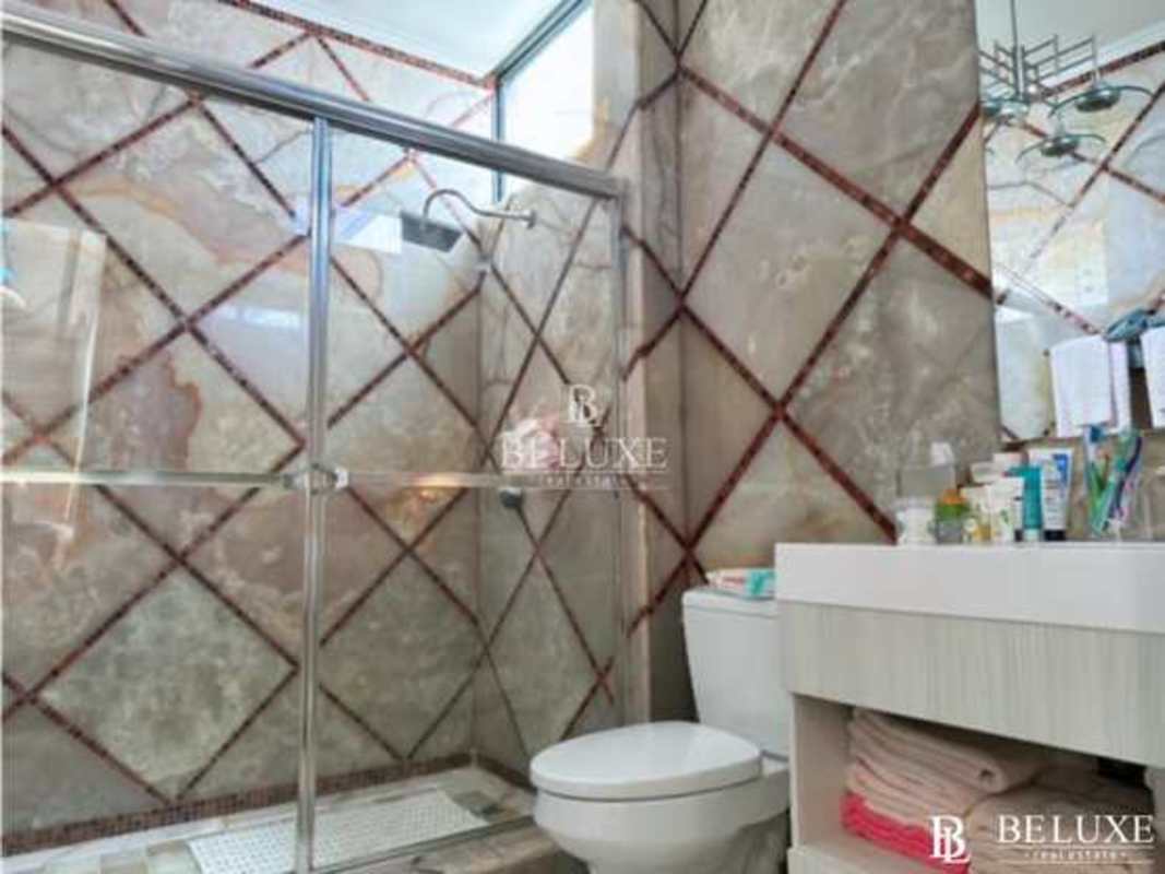 Elegant master bedroom suite with chandelier and luxury finishes at PH Bayside Panama City