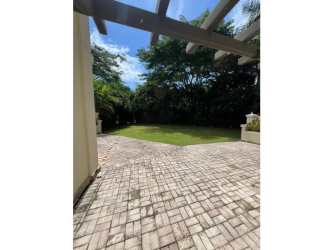 Outdoor patio area with pergola green lawn Buenaventura beach condo Panama