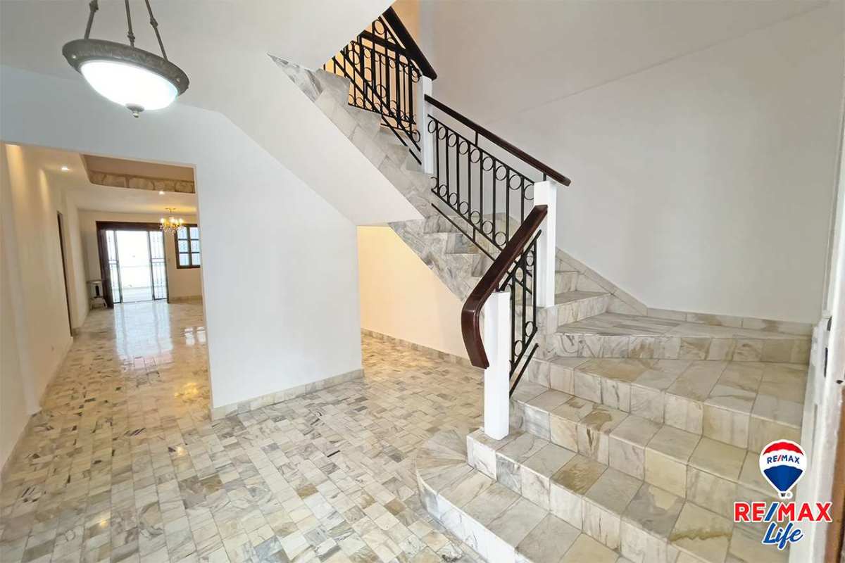 Kitchen with stainless counters, wooden cabinets, ceiling fan in Betania La Alameda home