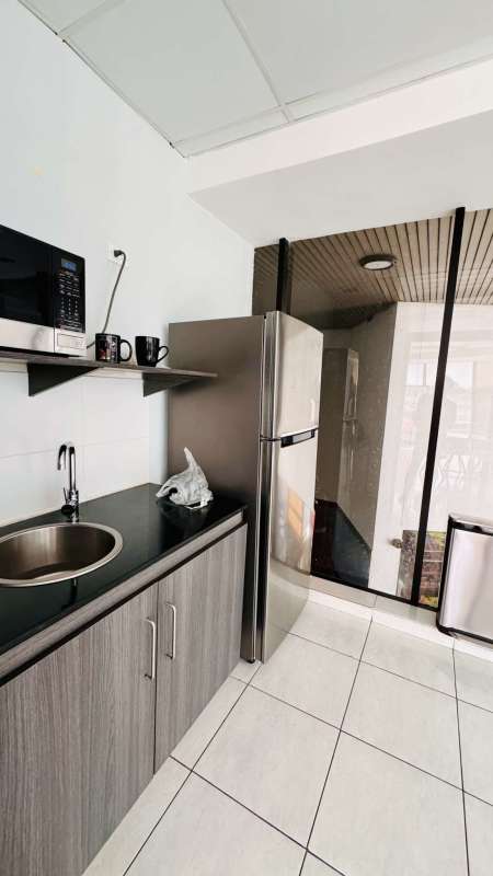 Small modern kitchenette with appliances in commercial office PH Plaza Edison