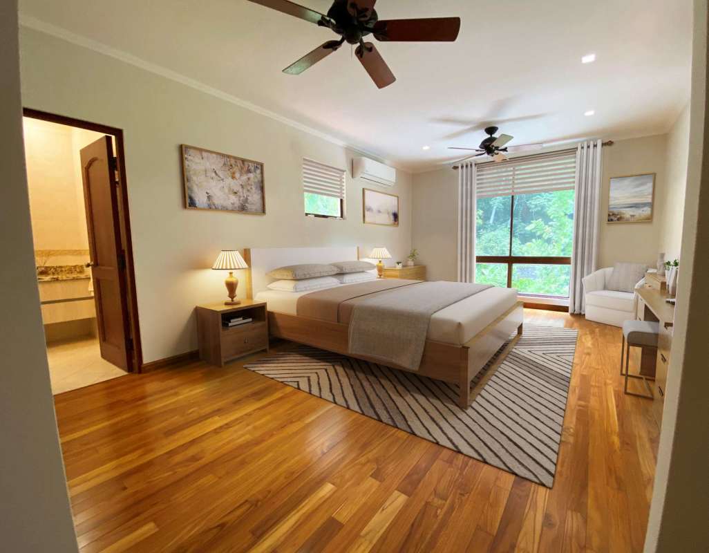 Double-height entrance, stone columns, lush landscaping at Camino de Cruces luxury house Panama City