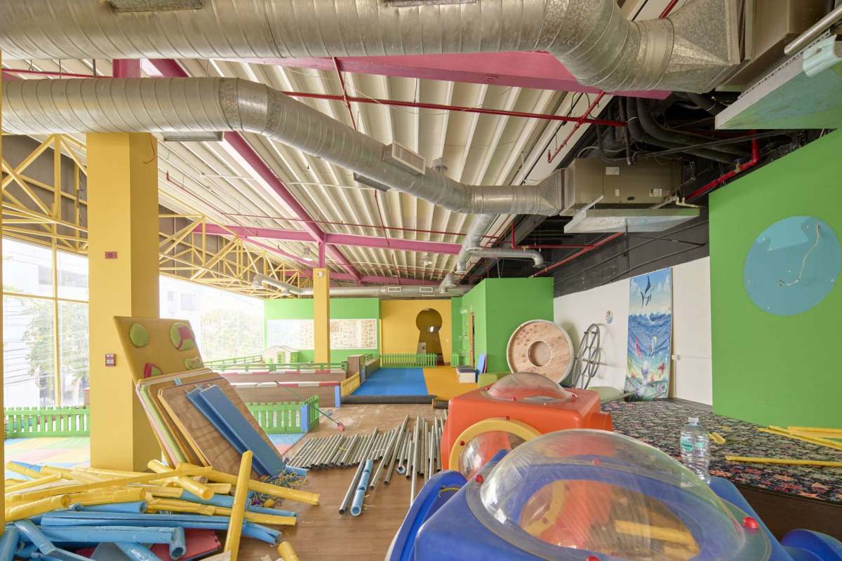 Cafeteria lounge with glass walls white chairs and city views commercial rental PH Marbella Plaza