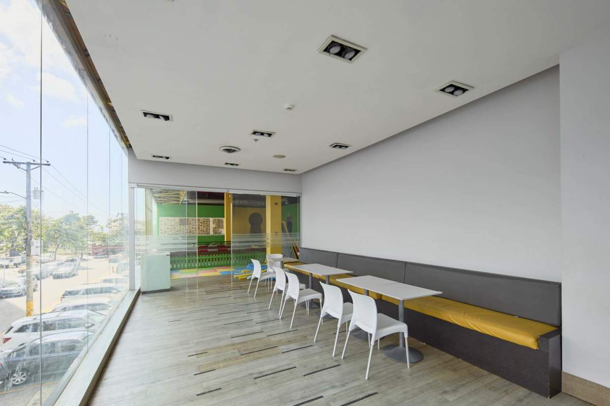 Reception lounge with yellow accents glass walls overlooking kids play area in commercial rental PH Marbella Plaza Panama