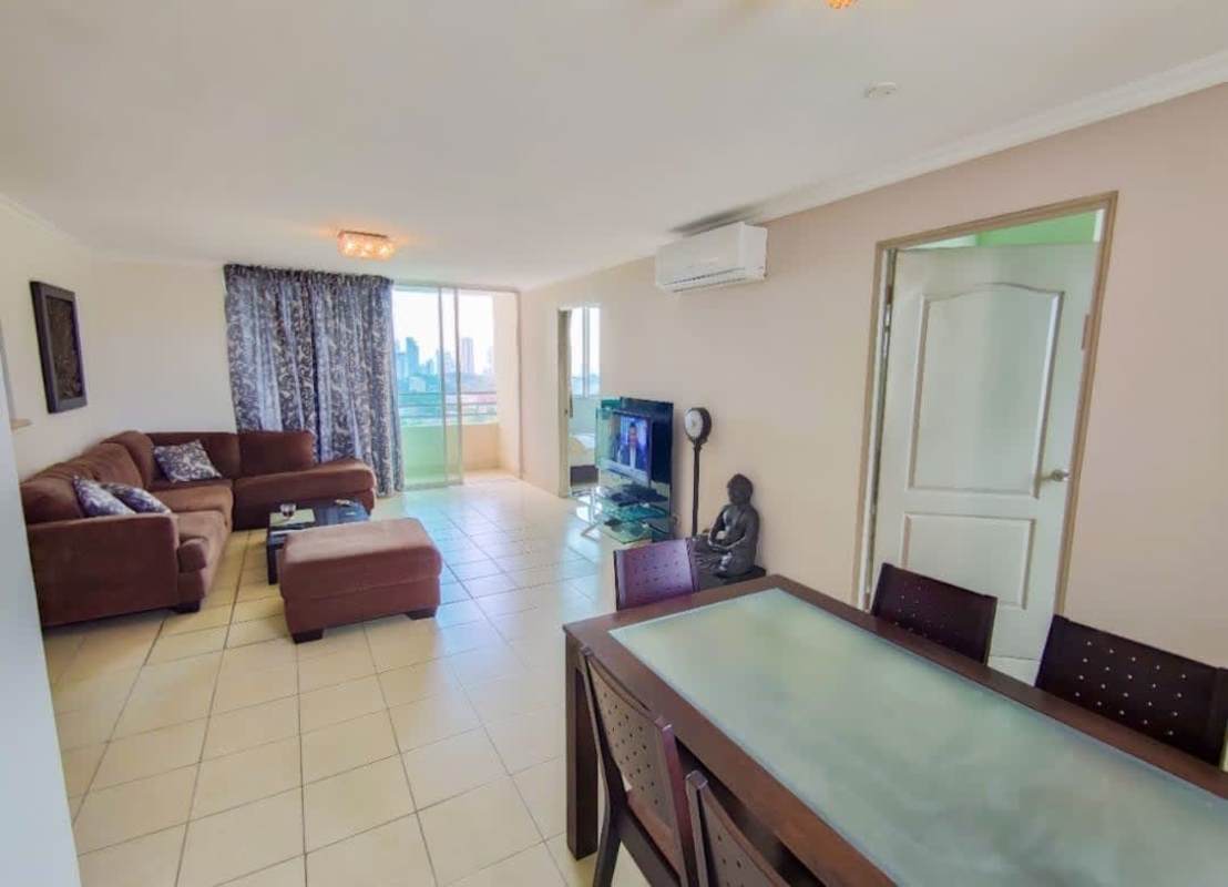 Open plan living and dining room with large windows and city views at PH Edison Park Panama