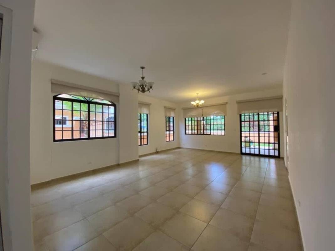 Bright living room with large windows, chandeliers, tiled floors in Mediterranean villa Clayton Panama