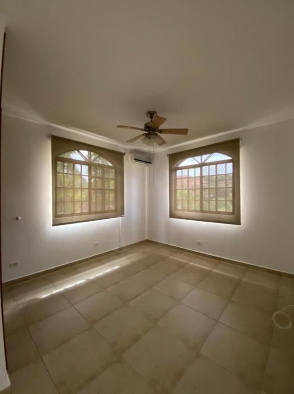 Bright bathroom with bathtub, large window and modern fixtures in Clayton villa
