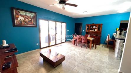 Open-plan living and dining with tile floors and large window David Panama