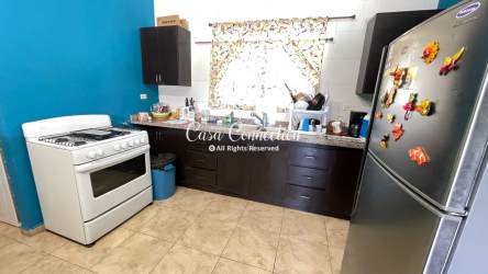 Kitchen with granite countertops, custom wood cabinetry and gas stove David Panama