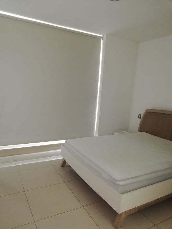 Bedroom with panoramic window blinds light furniture PH Mirador Costa del Este Panama