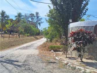 Paved and dirt road leading to the entrance of the large beach property in San Carlos Panama