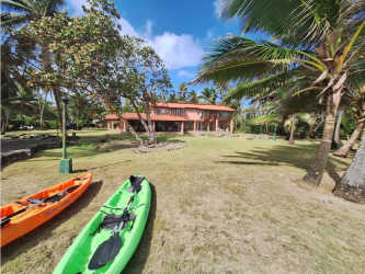 Lush tropical garden with palm trees at beachfront property Santa Isabel Colón Panama