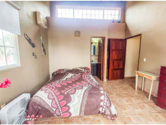 Large bedroom with balcony, ocean view, wood ceiling at Caribbean villa Santa Isabel Colón Panama