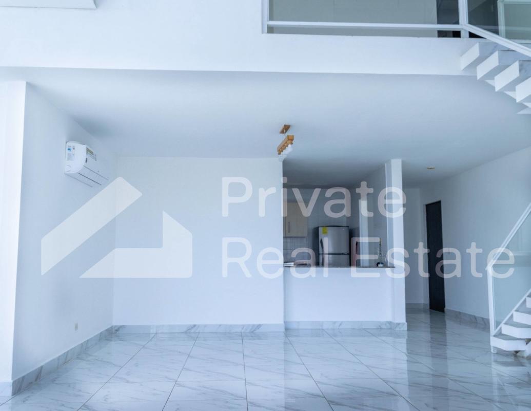 Modern dining area with floating staircase loft design in PH Blue Park Panama
