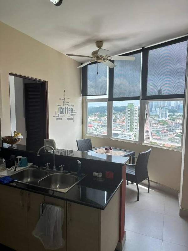 Modern kitchen open plan with breakfast nook large windows and city view at PH Vista Park El Carmen Panama