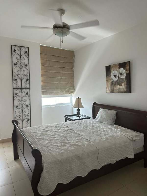 Bright modern bedroom with wood furniture ceiling fan and curtains PH Vista Park Panama City