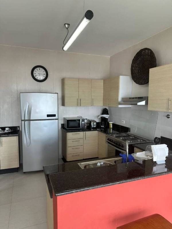 Kitchen with granite counters stainless appliances breakfast bar in PH Vista Park El Carmen Panama City